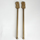a pair of gold pineapple swizzle sticks from madcap cottage