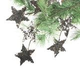 gold and silver stara hainging on a branch