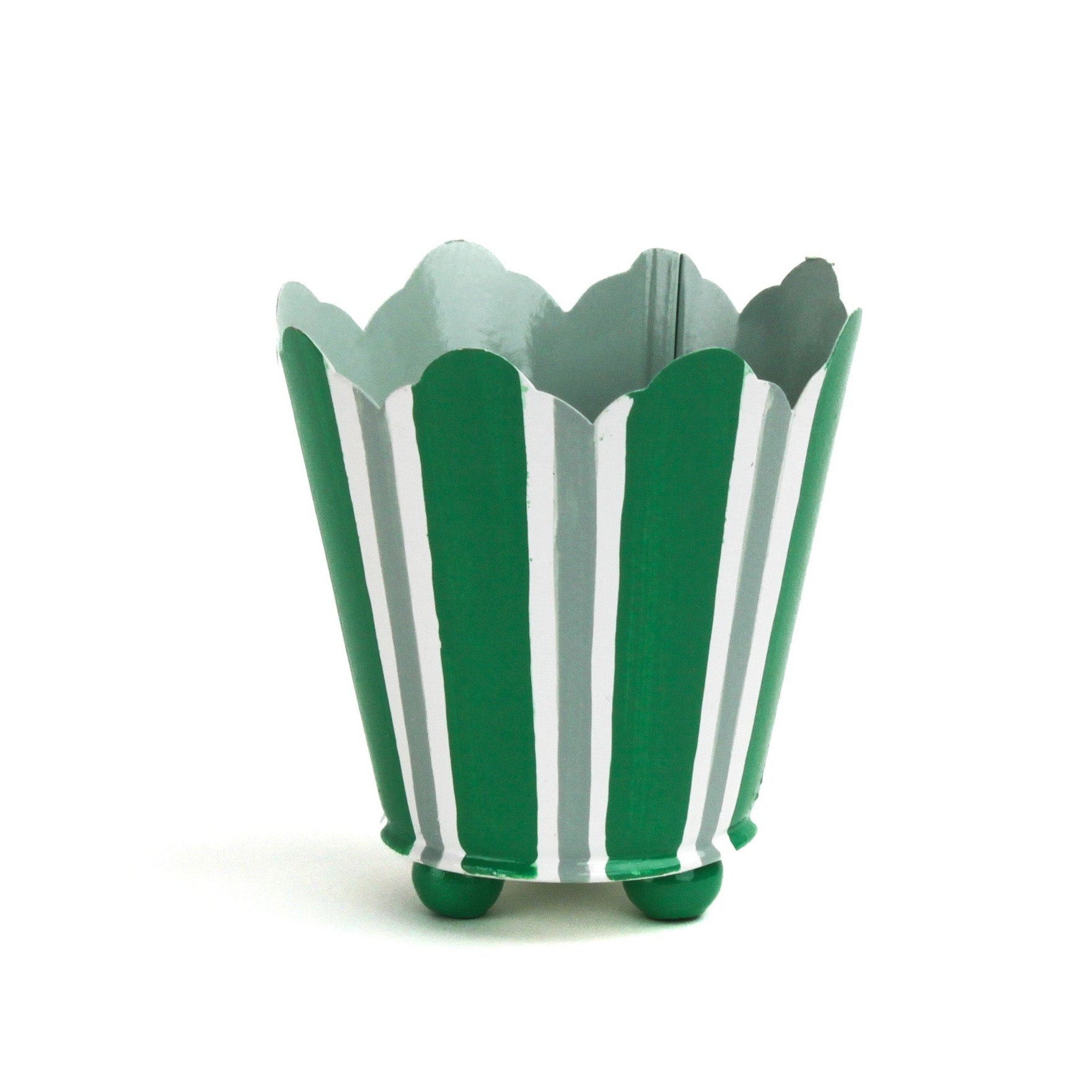 Green and white striped tole cachepot with scalloped rim and rounded green feet, standing upright.