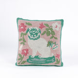 Square decorative pillow with a hooked texture, featuring a white pug with green details surrounded by pink, white, and green floral accents on a blush pink background.