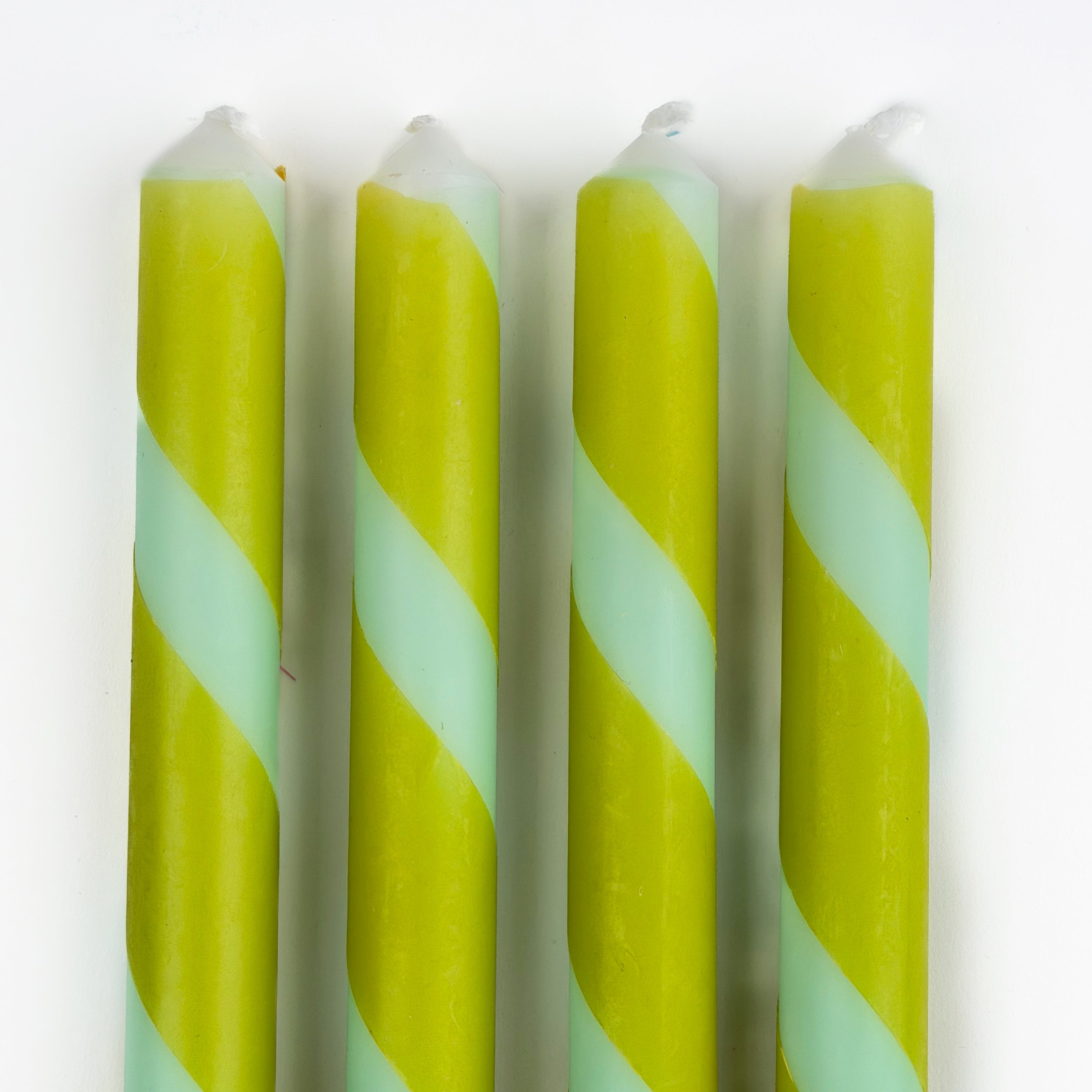 Green and blue candy stripe taper candles set with twisted spiral design for spring table decor.
