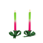 set of green bow shaped candle holders with green and pink candle and a glossy finish on white background
