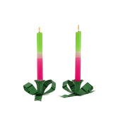 set of green bow shaped candle holders with green and pink candle and a glossy finish on white background