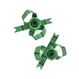 top view of green bow shaped candle holders with glossy finish on white background