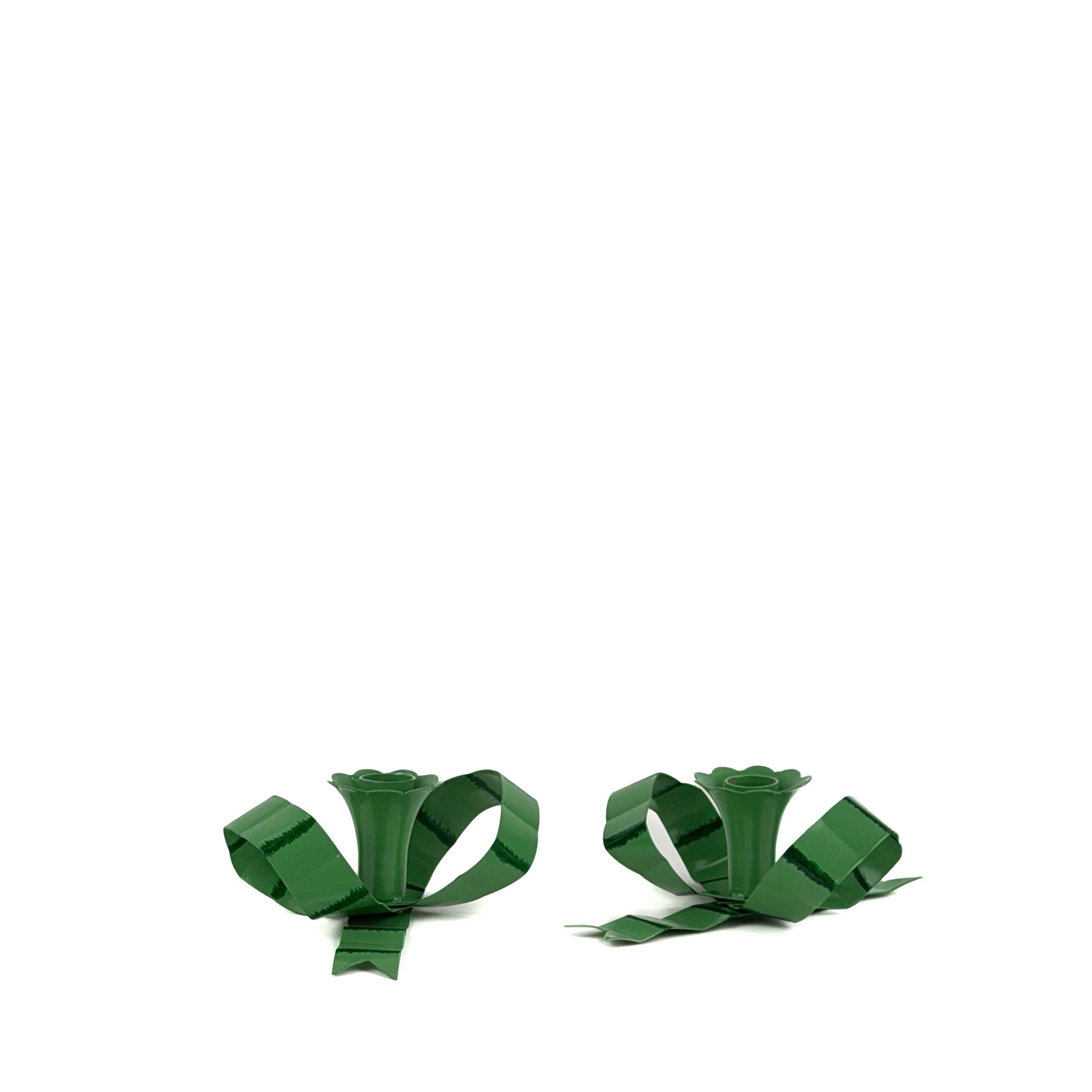 set of green bow shaped candle holders with glossy finish on white background