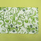 a green and white cloth table runner in a  bunny and bow print fabric