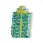 a green christmas accent plate in the shape of a christmas gift. 