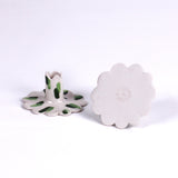 Set of two white ceramic scalloped taper candle holders with green brushstroke accents, shown from the top and side angles on a light background.