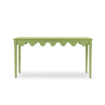 A green console table with scalloped edges