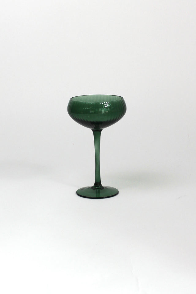 a green coupe glass on a white background from madcap cottage