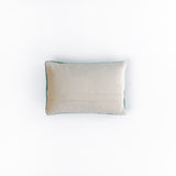 back of a rectangular green decorative pillow with a hooked texture, featuring two crossed golf clubs and a small white golf ball in the center.