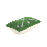 a rectangular green decorative pillow with a hooked texture, featuring two crossed golf clubs and a small white golf ball in the center.