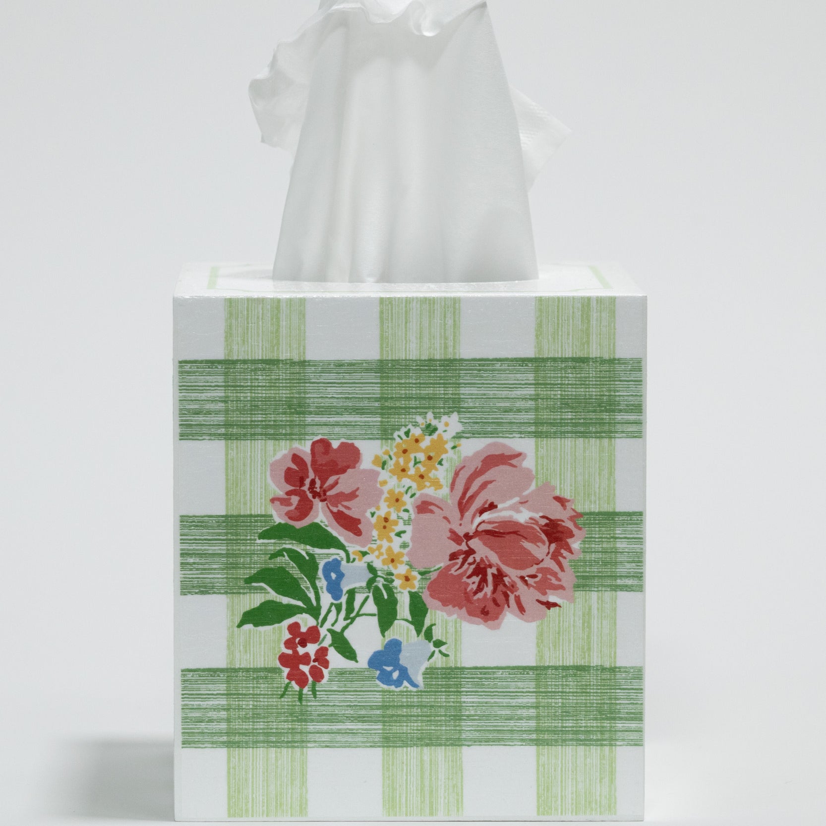 Tissue box cover with floral design and green plaid pattern on a white background