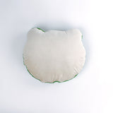 reverse back of a Frog-shaped decorative pillow with a hooked texture, featuring a smiling green frog face with pink cheeks and large black eyes.