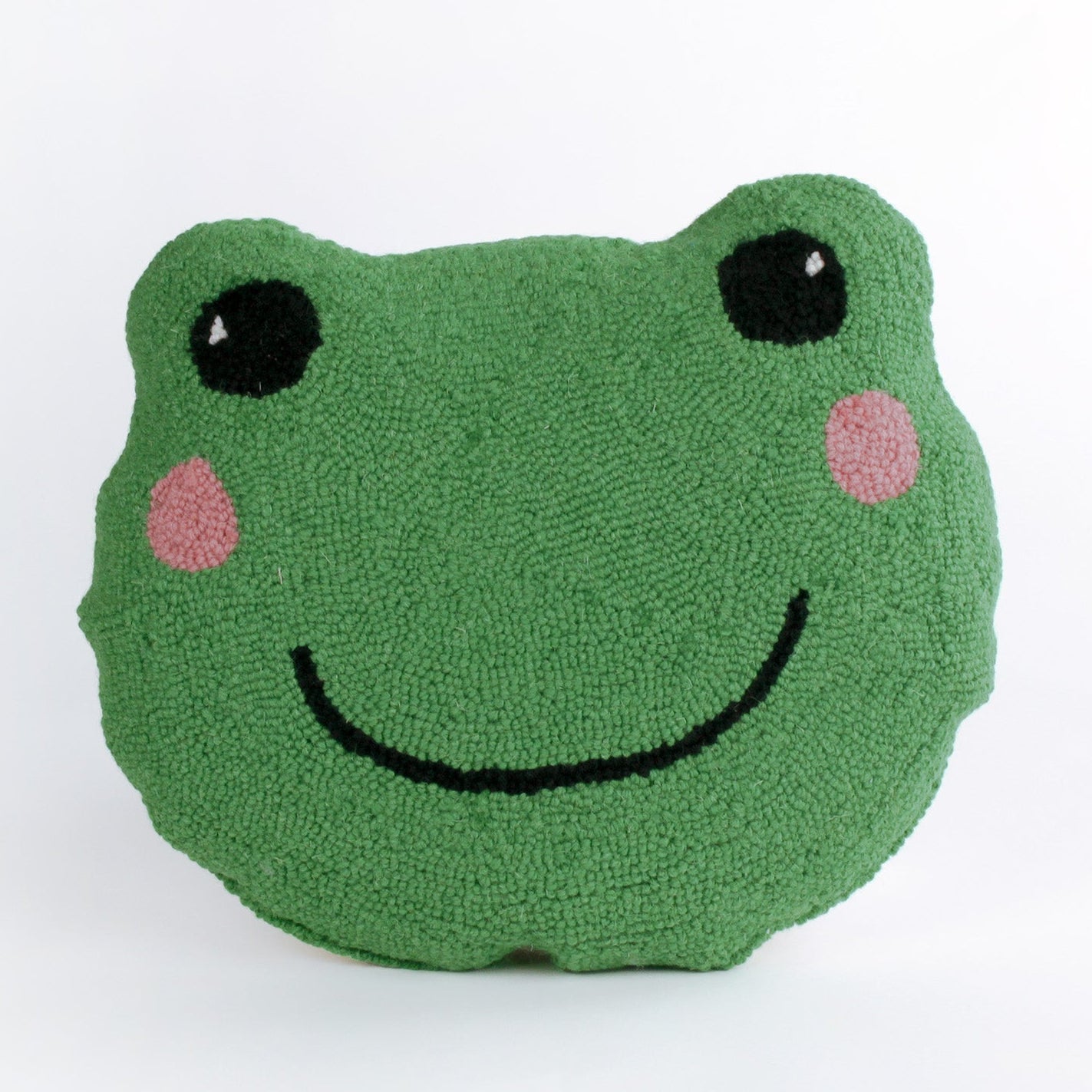 Frog-shaped decorative pillow with a hooked texture, featuring a smiling green frog face with pink cheeks and large black eyes.