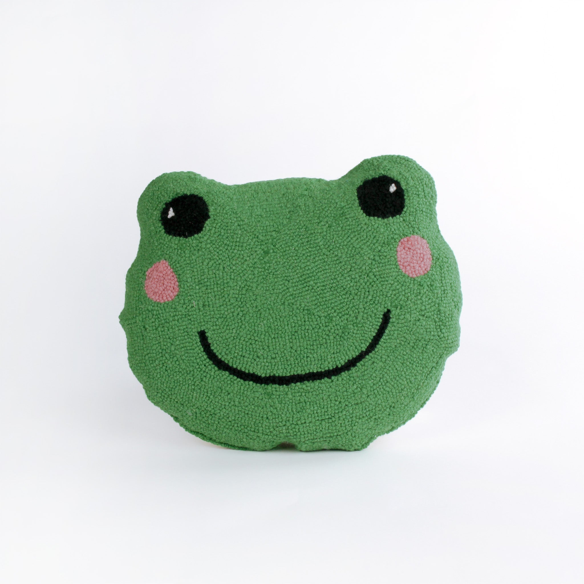 Frog-shaped decorative pillow with a hooked texture, featuring a smiling green frog face with pink cheeks and large black eyes.