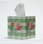 Tissue box with floral green gingham design on a white background