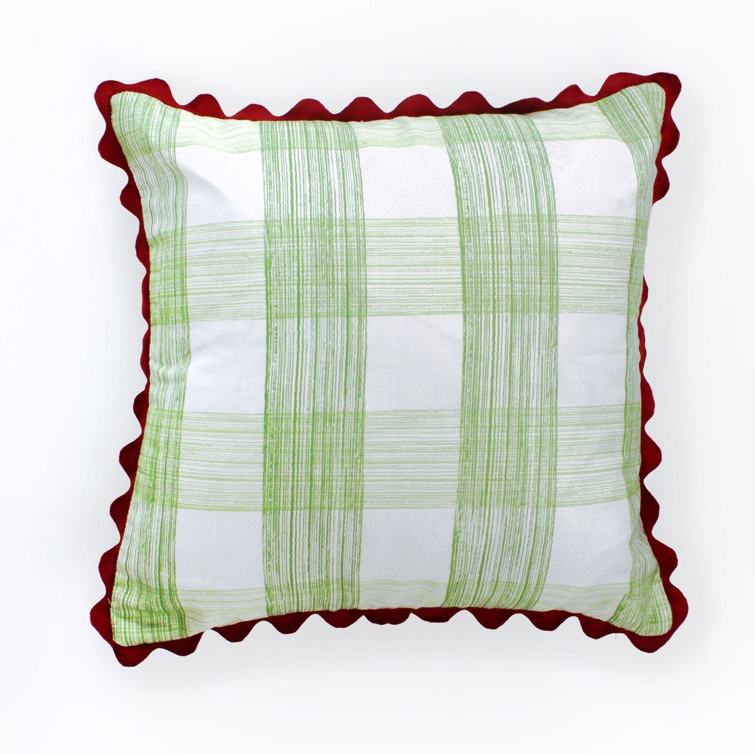 Square decorative pillow with a light green gingham plaid pattern on a white background, finished with a red scalloped trim around the edges.