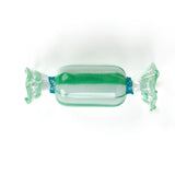 Green glass candy christmas ornament on a white background