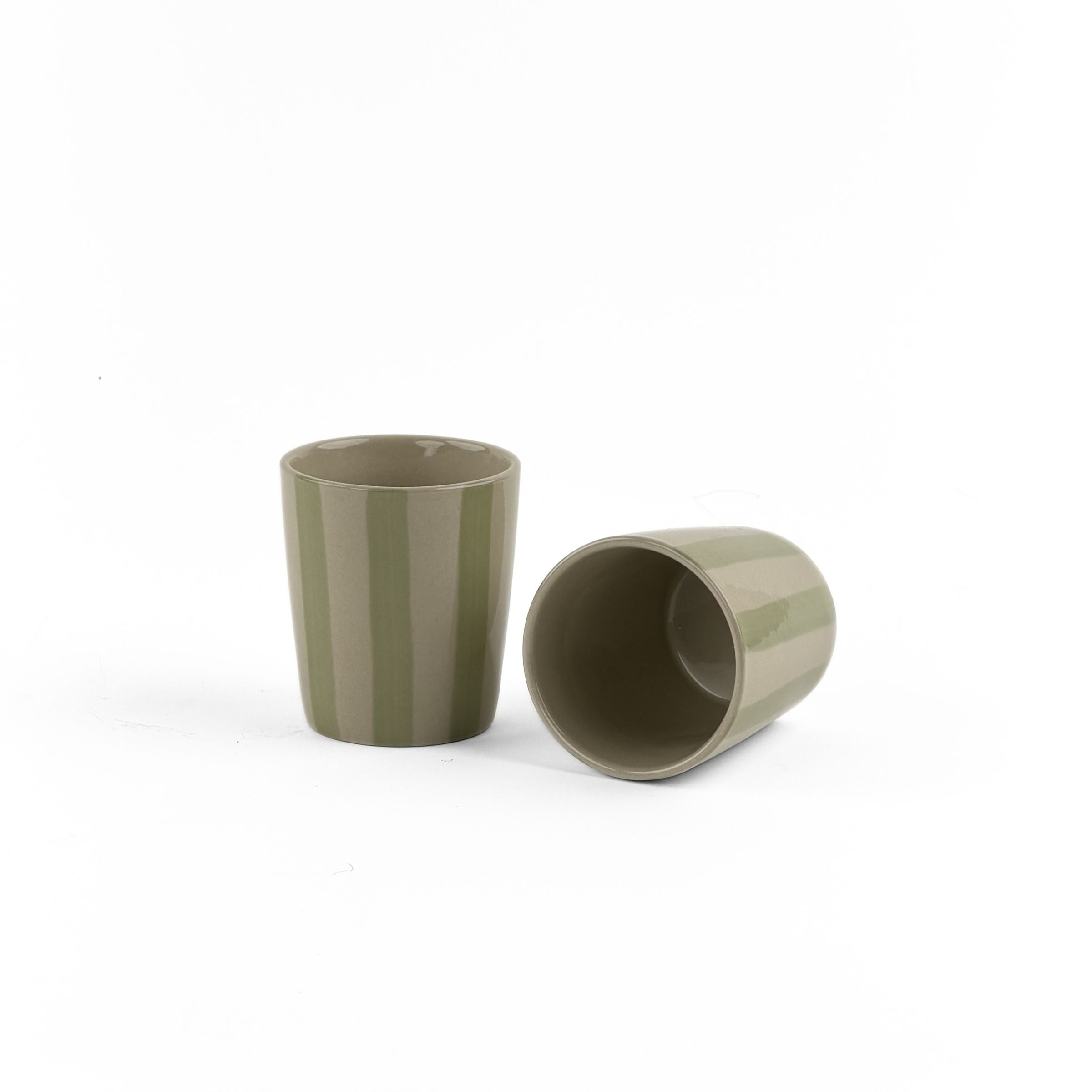 Two green ceramic cups on a white background