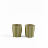 Two green striped ceramic cups on a white background