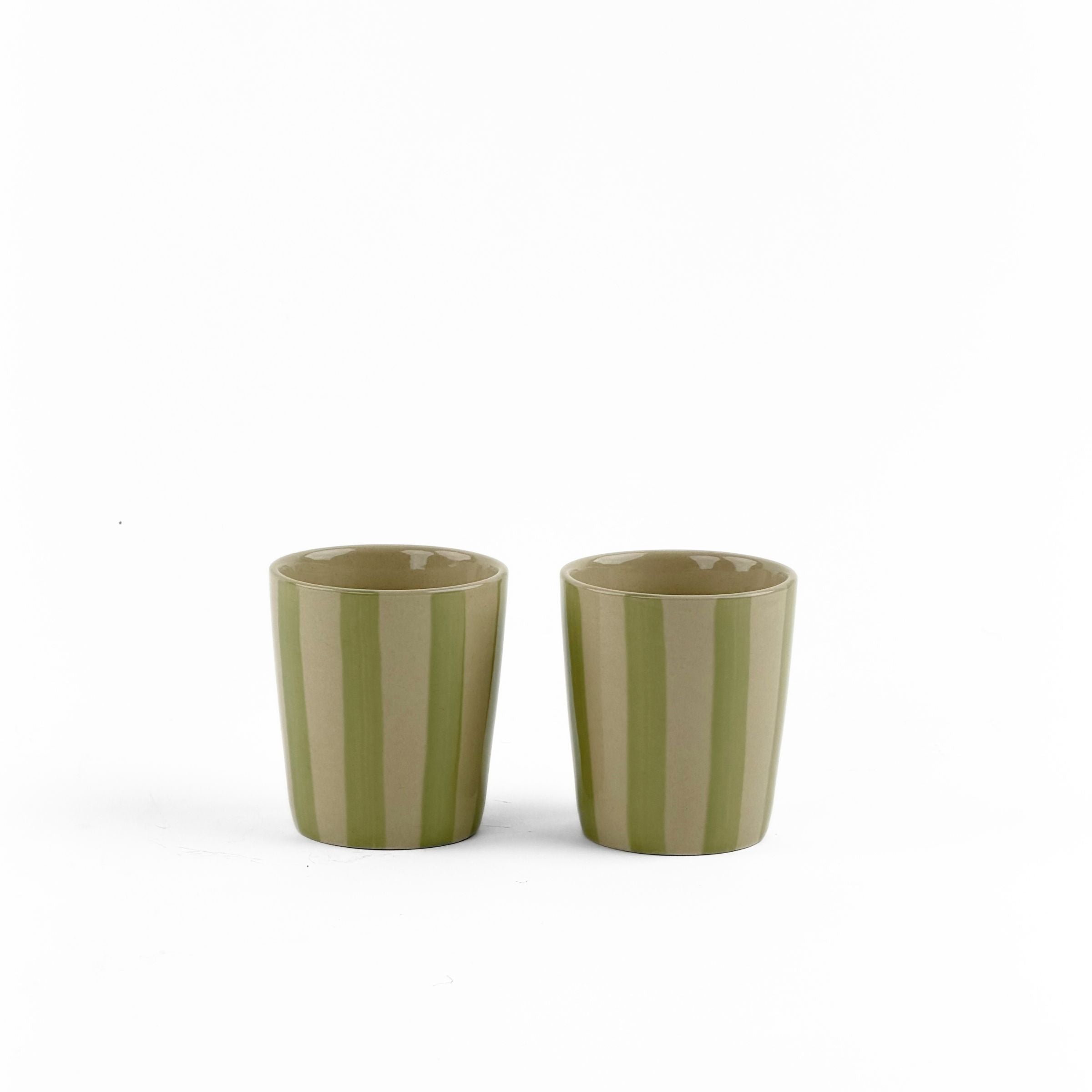 Two green striped ceramic cups on a white background