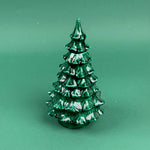Green marbled Christmas tree ornament on a solid green background