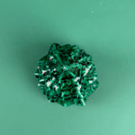 Green marbled Christmas tree ornament on a solid green background