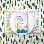 spring Easter paper placemat with bunny place card, white plate, and green striped napkin.