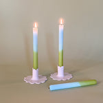 blue and green taper candles in white scalloped candle holders