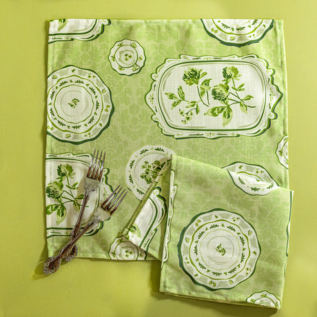 Green vintage plates fabric napkins against a green background. 