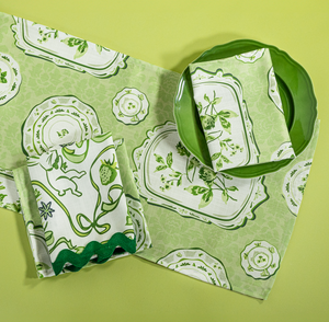 Green table runner in a vintage plates print fabric with matching napkins. 