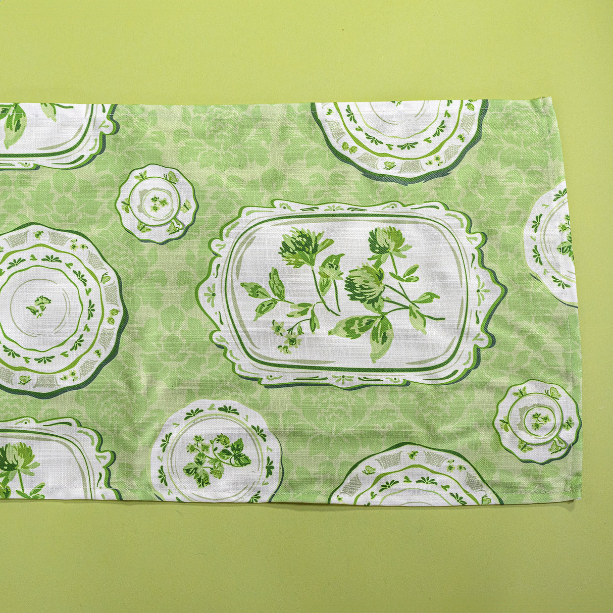 Green table runner in a vintage plates print fabric. 