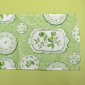 Green table runner in a vintage plates print fabric. 