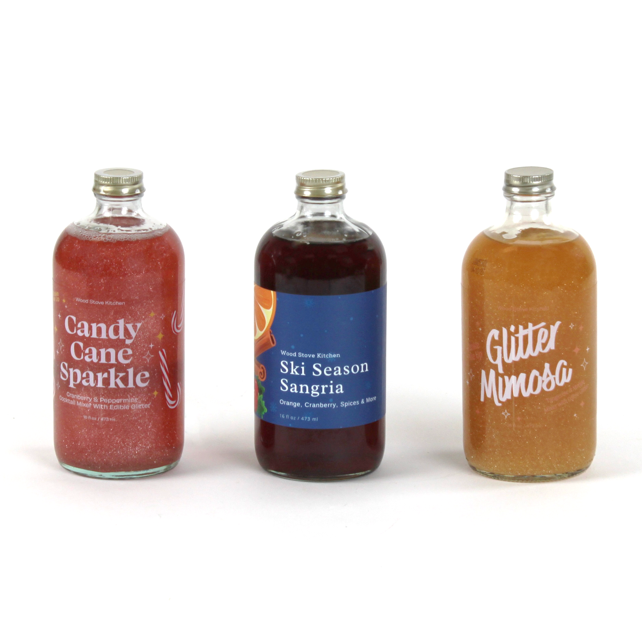 Holiday drink mixer trio featuring Candy Cane Sparkle, Ski Season Sangria, and Glitter Mimosa bottles.