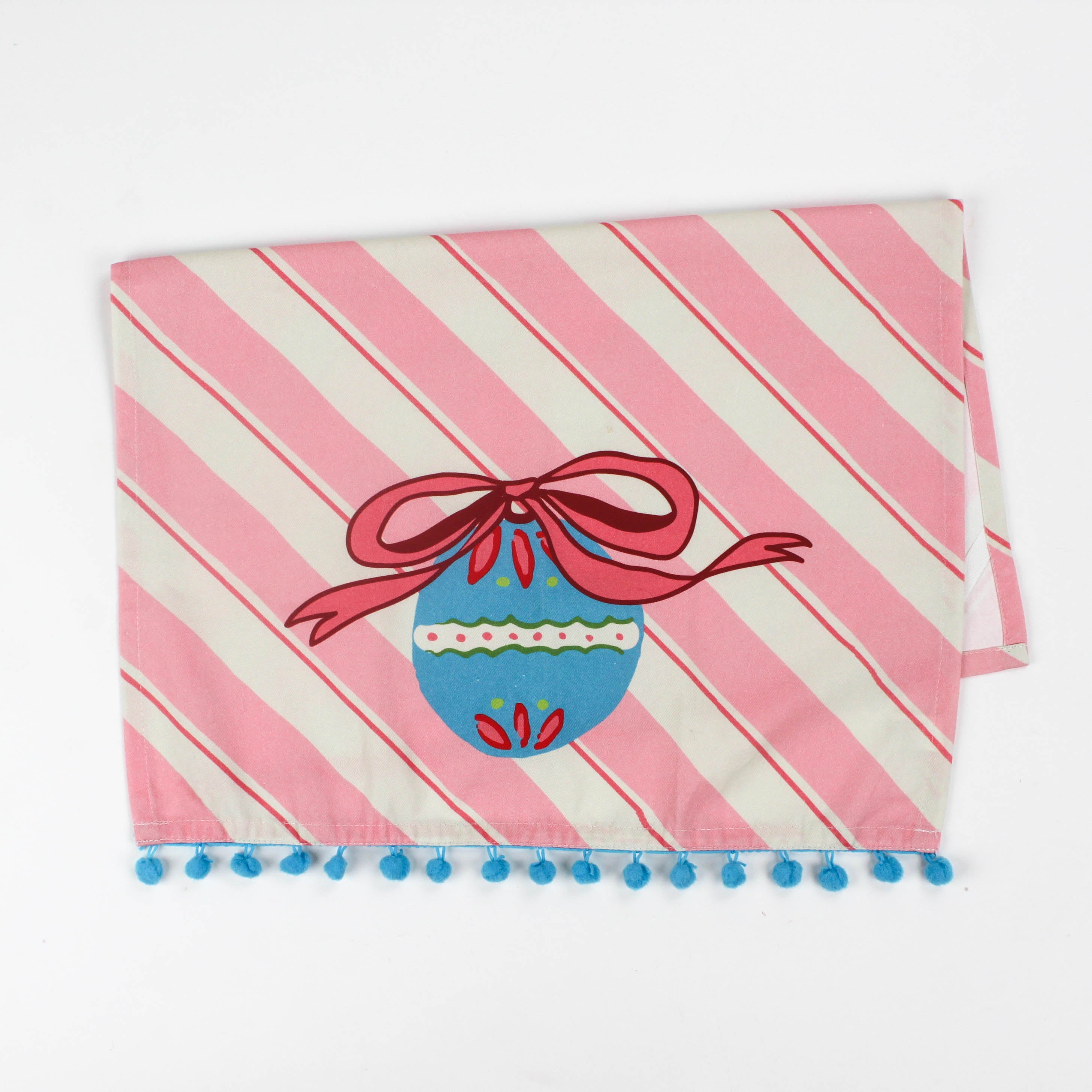 striped pink christmas tea towel with a blue ornament and pink bow central motif on a white background. 
