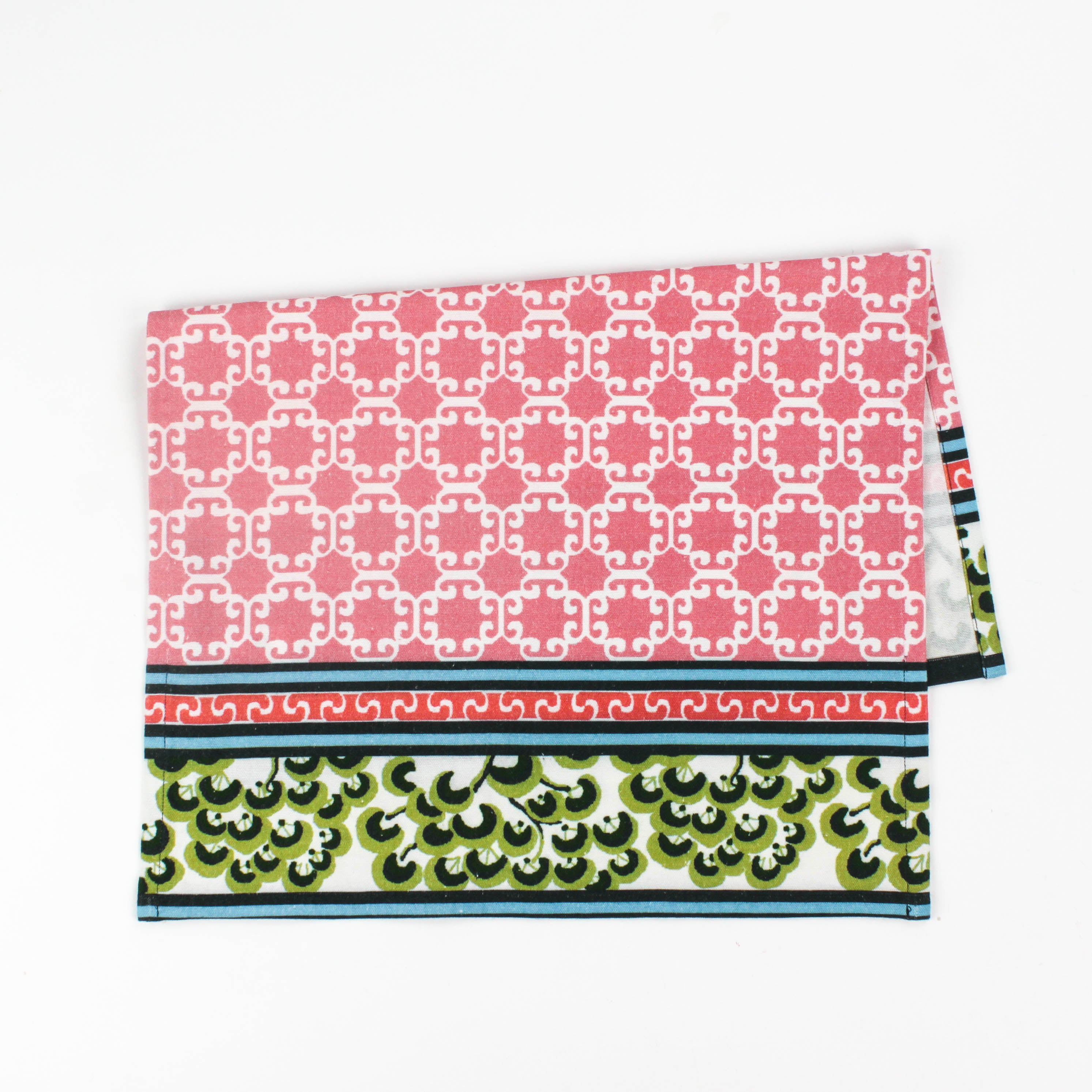Christmas tea towel featuring a pink lattice pattern with green and white Chinoiserie-inspired borders