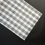 a black halloween paper table runner in a black and white gingham pattern from madcap cottage