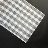 a black halloween paper table runner in a black and white gingham pattern from madcap cottage
