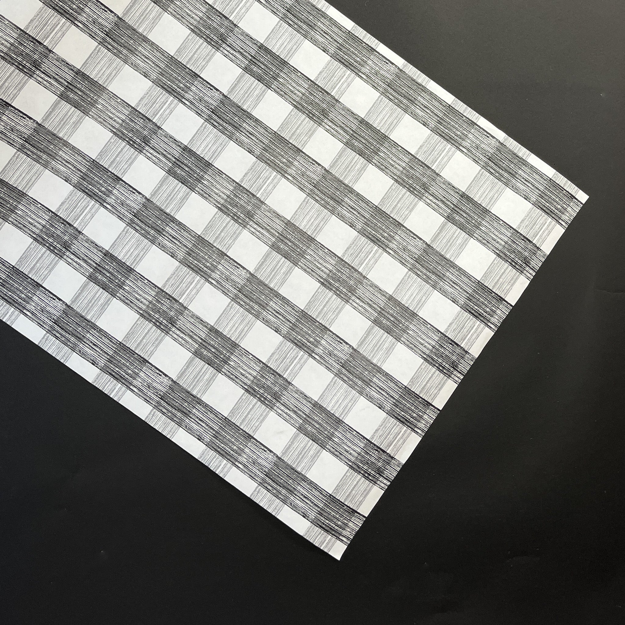 a black halloween paper table runner in a black and white gingham pattern from madcap cottage