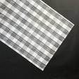 a black halloween paper table runner in a black and white gingham pattern from madcap cottage