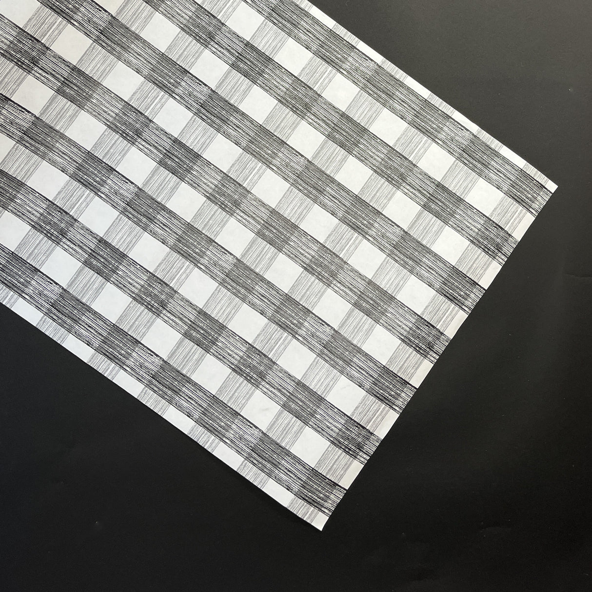 a black halloween paper table runner in a black and white gingham pattern from madcap cottage