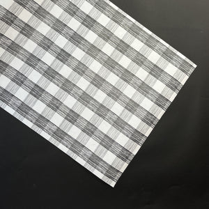 a black halloween paper table runner in a black and white gingham pattern from madcap cottage