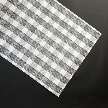 a black halloween paper table runner in a black and white gingham pattern from madcap cottage