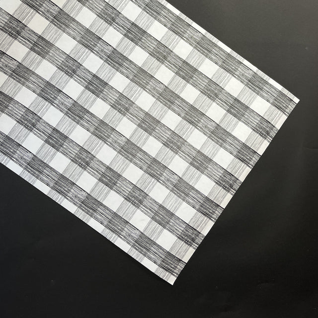 a black halloween paper table runner in a black and white gingham pattern from madcap cottage