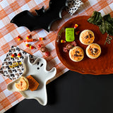 a collection of three ceramic serving platters in the shapes of a ghost, pumpkin and bat