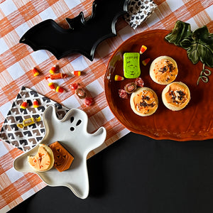 a collection of three ceramic serving platters in the shapes of a ghost, pumpkin and bat