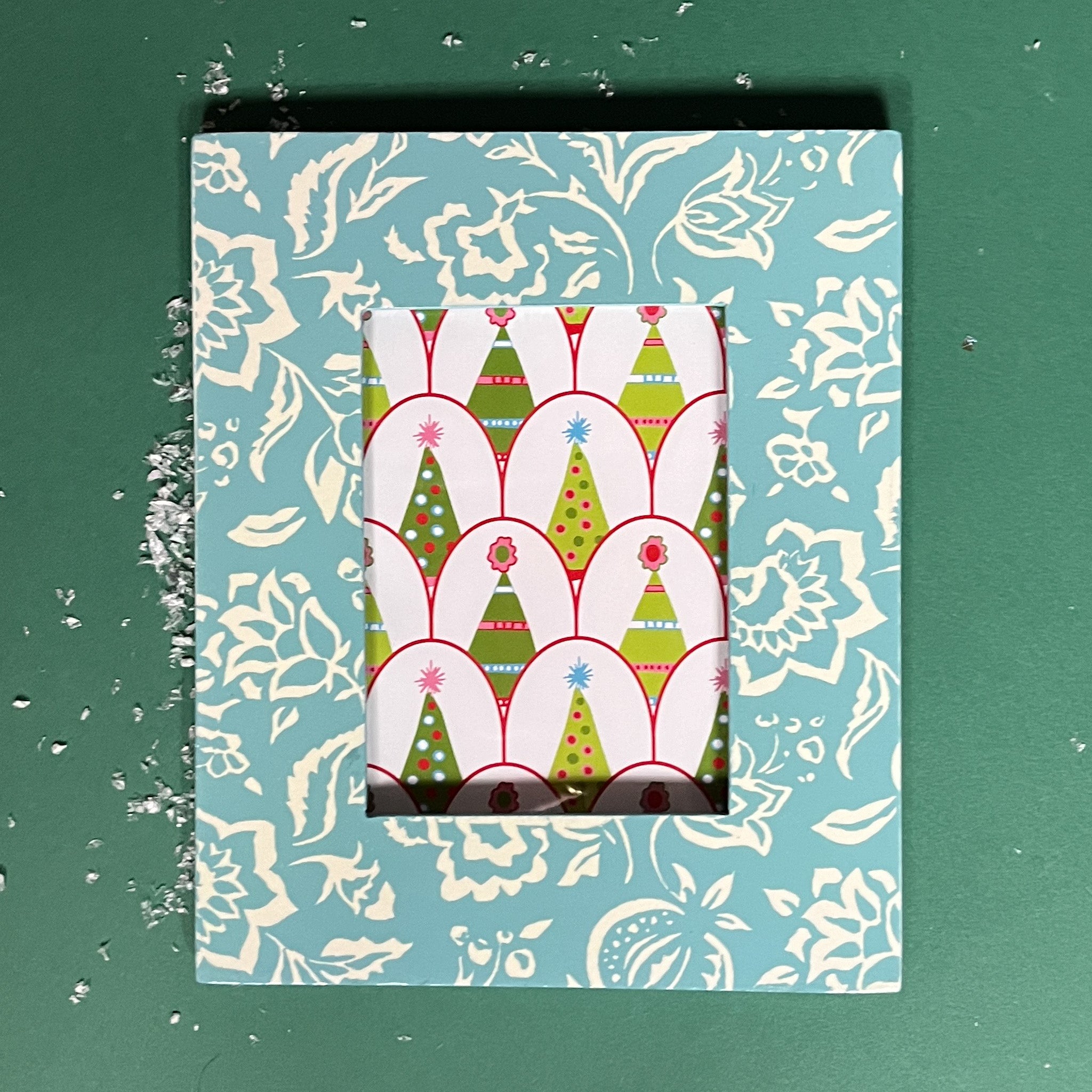 a Hampton Court hand painted photo frame on a green background