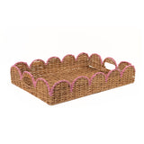 A rectangular woven rattan tray with scalloped edges and pink rope trim on a plain white background.