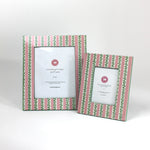 a set of two Hand painted picture frames featuring a pink and white striped motif